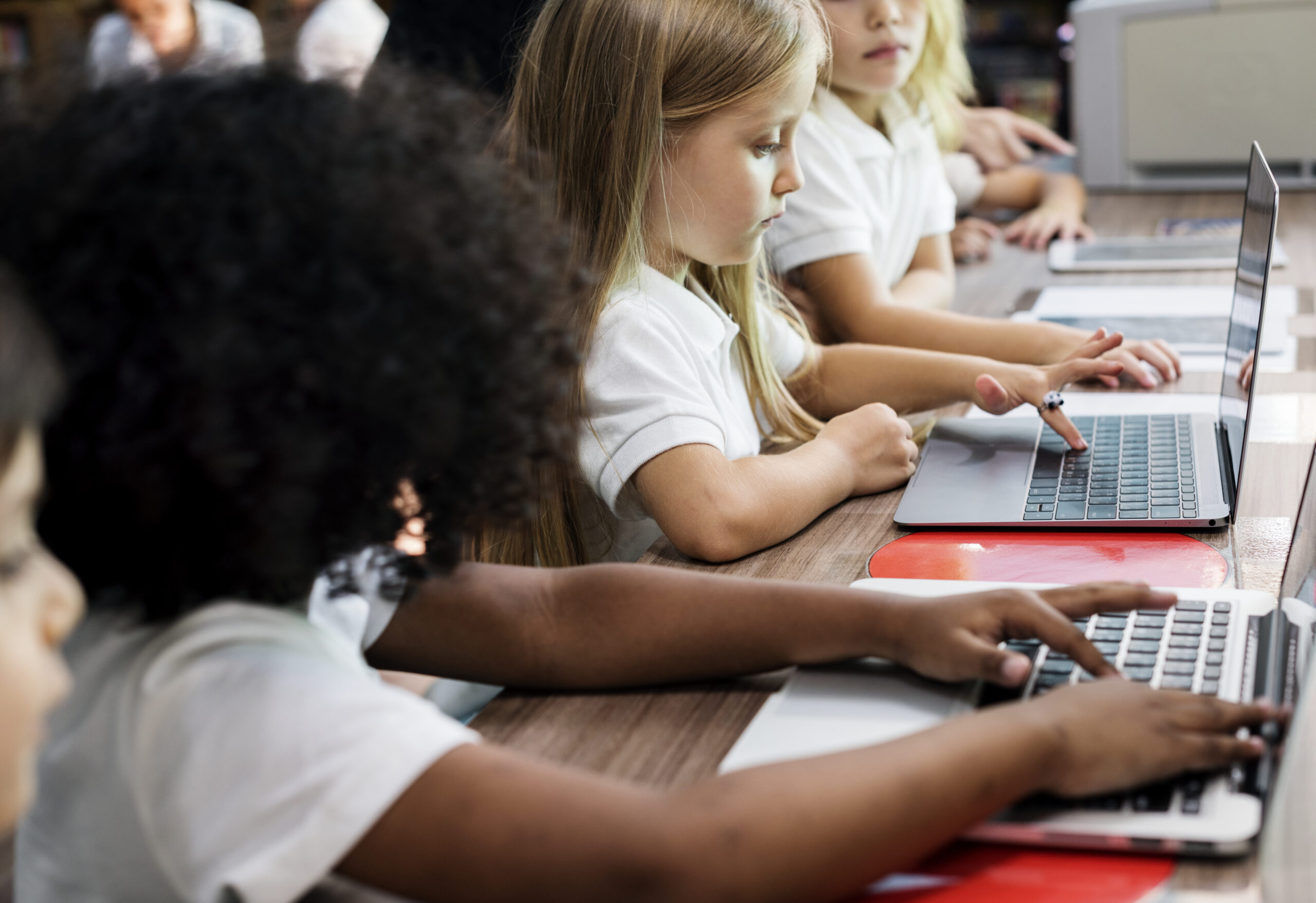 Enfants travaillant sur des ordinateurs dans une école primaire